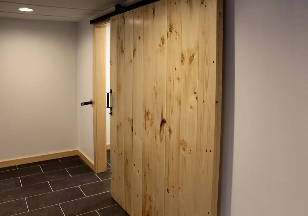 Barn Door installation with Tile Flooring by Polli Construction.